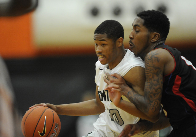 Palo Verde guard Ja Morgan, left, brings the ball down the court as guard Cameron Burton defends in the first quarter of the Division I boys state play-in game on Monday. Morgan had 18 of his 20 p ...
