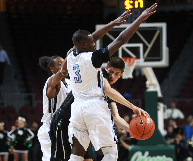 Palo Verde's Connor Lemmon is pressured by Canyon Springs' Maurice Hunter, left, and Greg Banks during their Division I state semifinal game Thursday, Feb. 26, 2015, at the Orleans Arena. (Sam Mor ...