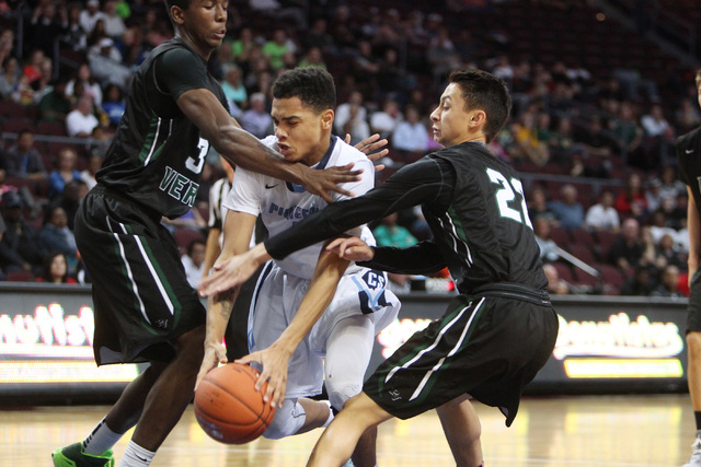 Canyon Springs guard Jordan Davis is fouled by Palo Verde forward amell Garcia-Williams and guard Taylor Miller during their Division I state semifinal game Thursday, Feb. 26, 2015, at the Orleans ...