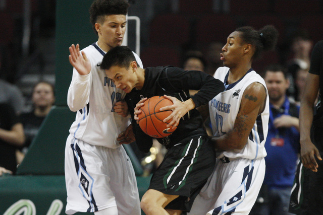 Palo Verde guard Taylor Miller is defended by Canyon Springs guard Channel Banks and forward Maurice Hunter during their Division I state semifinal game Thursday, Feb. 26, 2015, at the Orleans Are ...