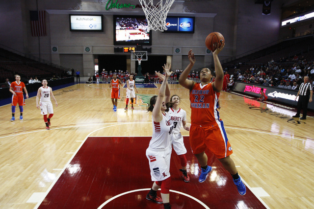 Bishop Gorman forward Raychel Stanley drives past Liberty forward Nancy Caballero for a layup during their Division I state semifinal game Thursday, Feb. 26, 2015, at the Orleans Arena. Bishop Gor ...
