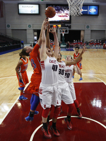Bishop Gorman guard Megan Jacobs knocks a rebound away from Liberty forward Nancy Caballero during their Division I state semifinal game Thursday, Feb. 26, 2015, at the Orleans Arena. Bishop Gorma ...