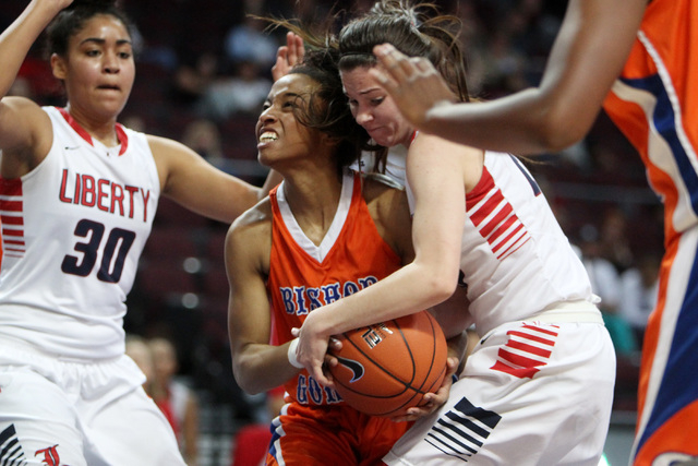 Bishop Gorman forward Alaysia Robinson gets in a held ball situation with Liberty guard Kealy Brown during their Division I state semifinal game Thursday, Feb. 26, 2015, at the Orleans Arena. Bish ...