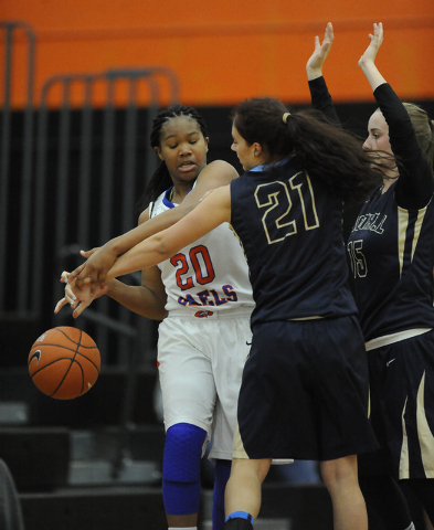 Bishop Gorman guard Skylar Jackson (20) turns over the ball as Foothill's Taylor Turney (21) and Nicole Benson (15) defend in the third quarter of the Division I state play-in game at Chaparral on ...