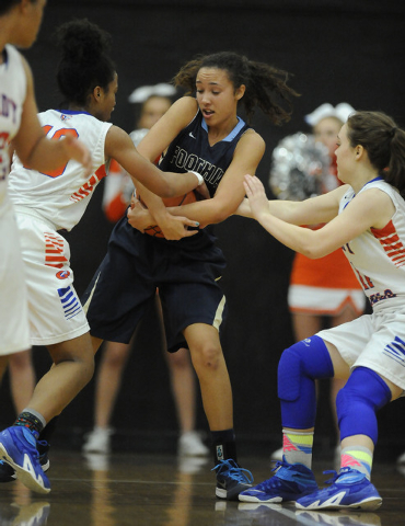 Foothill guard Katey Roquemore, center, tries to secure the ball as Bishop Gorman's Alaysia Robinson and Madison Ulrey defend in the third quarter of the Division I state play in game at Chaparra ...