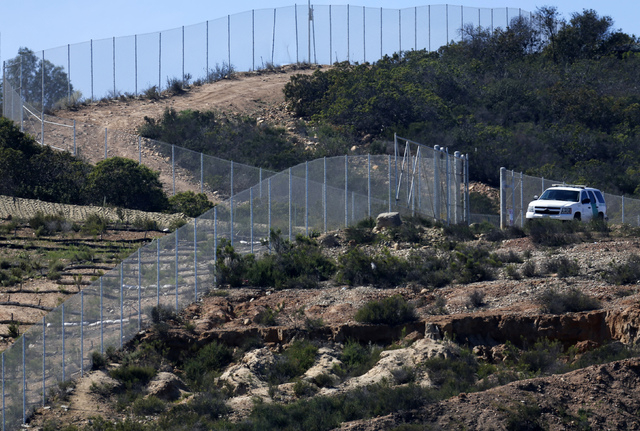A U.S. border patrol officer sits in his vehicle along the border with Mexico near San Ysidro, California February 25, 2015. (REUTERS/Mike Blake)