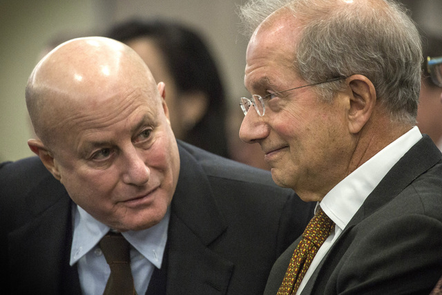 Ronald O. Perelman,left,  chairman of Scientific Games, talks to Barry F. Schwartz, Scientific Games executive vice chairman, during the Nevada Gaming Control Board hearing on the company's  buyou ...