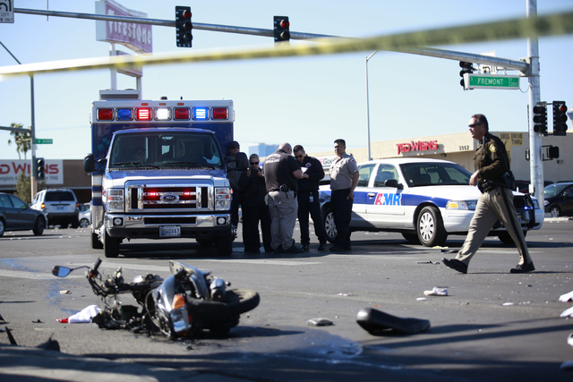 Las Vegas police investigate the scene of a fatal accident involving a scooter and an ambulance at the intersection of Sahara Avenue where Fremont Street becomes Boulder Highway in Las Vegas on Mo ...