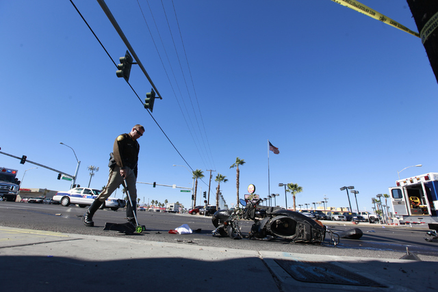 Las Vegas police investigate the scene of a fatal accident involving a scooter and an ambulance at the intersection of Sahara Avenue where Fremont Street becomes Boulder Highway in Las Vegas on Mo ...