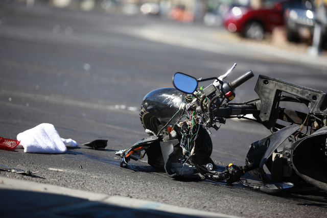 Las Vegas police investigate the scene of a fatal accident involving a scooter and an ambulance at the intersection of Sahara Avenue where Fremont Street becomes Boulder Highway in Las Vegas on Mo ...