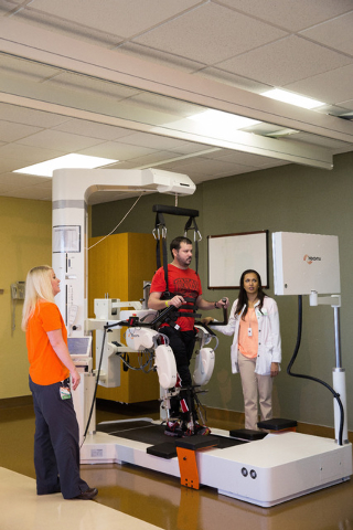 Former patient Josh Estrada models how to operate the Lokomat robot while nurses watch at St. Rose Dominican Hospitals Rose de Lima campus, 102 E. Lake Mead Parkway. (Special to View)