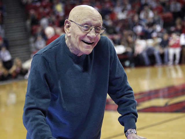 Hall of Fame coach Jerry Tarkanian walks across the floor named in his honor to his seat in order to watch the UNLV men's basketball team as they take on Boise State at the Thomas & Mack Center in ...
