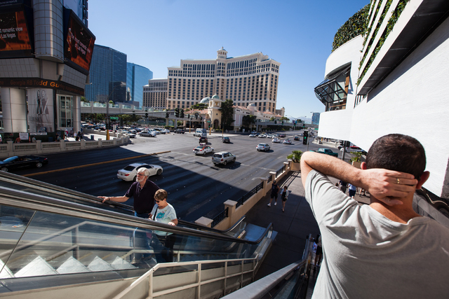 People take an escalator to and from a pedestrian bridge to cross Flamingo Road on Las Vegas Boulevard near The Cromwell hotel-casino in Las Vegas on Wednesday, Oct. 29, 2014. (Chase Stevens/Las V ...