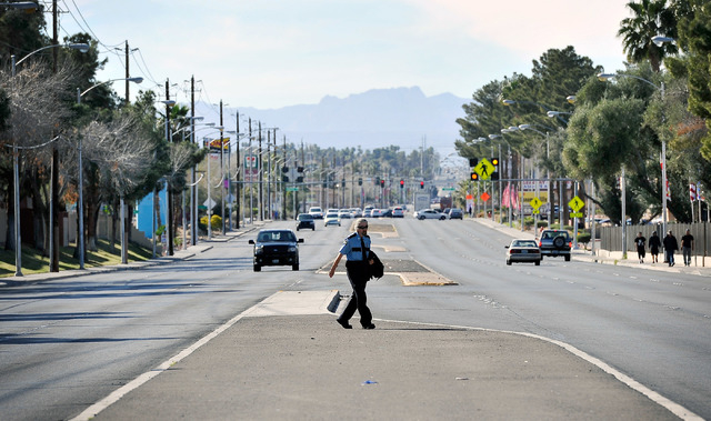 A pedestrian crosses a median along East Tropicana Avenue near Denning Street in Las Vegas on Thursday, Feb. 26, 2015. In addition to pedestrian safety projects, median barriers are scheduled to b ...