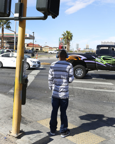 A pedestrian waits for a green light to cross Tropicana Ave., at the 5600 block of Boulder Hwy. and Tropicana Ave., Thursday, Feb. 26, 2015.  Improvements to Tropicana Avenue between Eastern Avenu ...