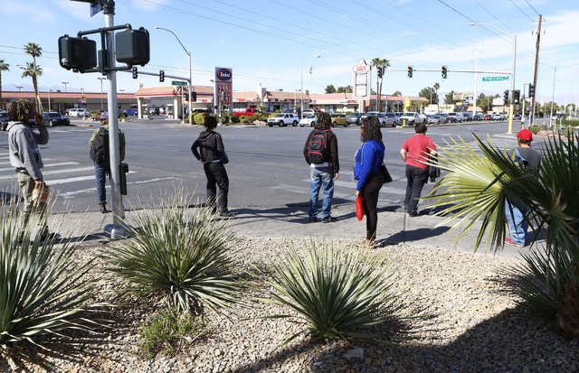 Pedestrians wait for a green light to cross Tropicana Ave., at the 3400 block of Tropicana and Pecos, Thursday, Feb. 26, 2015. Improvements to Tropicana Avenue between Eastern Avenue and Boulder H ...