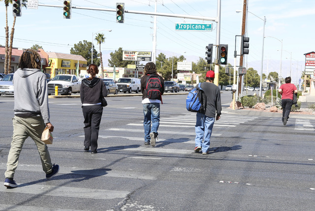 Pedestrians cross Tropicana Ave., at the 3400 block of Tropicana and Pecos, Thursday, Feb. 26, 2015.  Improvements to Tropicana Avenue between Eastern Avenue and Boulder Highway will include the w ...