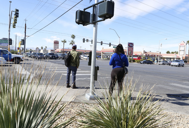 Pedestrians wait for a green light to cross Tropicana Ave., at the 3400 block of Tropicana and Pecos Rd., Thursday, Feb. 26, 2015.  Improvements to Tropicana Avenue between Eastern Avenue and Boul ...