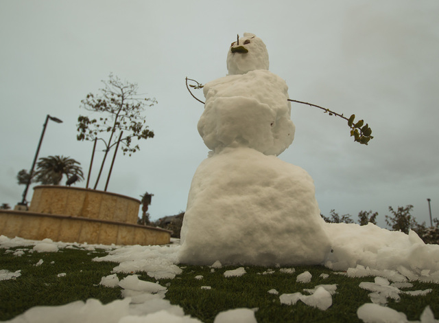 A snowman is seen on Sahara Avenue near Hualapai Way on Monday, Feb 23, 2015. A couple inches of snow fell overnight in the higher levels of the Las Vegas Valley.  (Jeff Scheid/Las Vegas Review-Jo ...