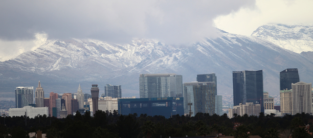 Snow covered mountains are seen on the background of The Strip in Las Vegas Monday, Feb. 23, 2015. (Erik Verduzco/Las Vegas Review-Journal)