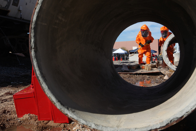 Members of the Nevada National Guard's 92nd Civil Support Team dig a diversion trench to move a simulated bleach spill away from a sewer system during an emergency preparedness drill Wednesday, Fe ...