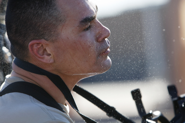 Sweat flies as SSgt. Mike Le removes his face mask during the Nevada National Guard's 92nd Civil Support Team's emergency preparedness drill Wednesday, Feb. 25, 2015. (Sam Morris/Las Vegas Review- ...