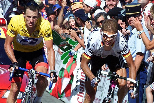 US Postal Service team rider and leader's yellow jersey holder Lance Armstrong (L) of the U.S. and Deutsche Telekom team rider Jan Ullrich of Germany climb up to Luz-Ardiden during the 144.5km 14t ...