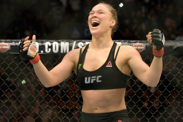 Ronda Rousey (red gloves) reacts after defeating Cat Zingano (not pictured) during their women's bantamweight title bout at UFC 184 at Staples Center. Rousey won in 14 seconds of the first round. ...
