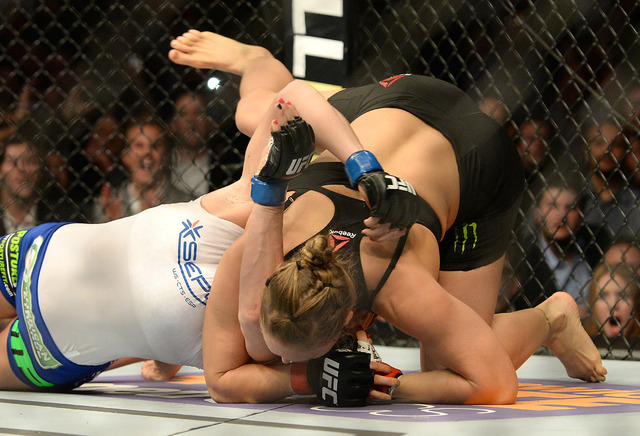 Feb 28, 2015; Los Angeles, CA, USA; Ronda Rousey (red gloves) and Cat Zingano (blue gloves) during their women's bantamweight title bout at UFC 184 at Staples Center. Rousey won in 14 seconds of ...