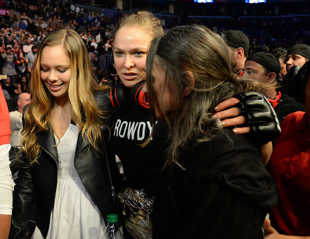 Feb 28, 2015; Los Angeles, CA, USA; Ronda Rousey leaves the arena with her sister Julia De Mars and mother AnnMaria De Mars after she defeated Cat Zingano (not pictured) in her women's bantamweig ...