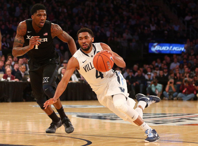 Mar 14, 2015; New York, NY, USA; Villanova Wildcats guard Darrun Hilliard (4) dribbles the ball around Xavier Musketeers forward Jalen Reynolds (1) during the second half of the Big East Tourname ...
