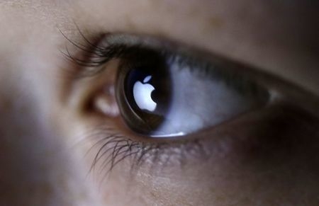 A picture illustration shows Apple Inc.'s logo reflected in a person's eye, March 13, 2015. (Reuters/Dado Ruvic)