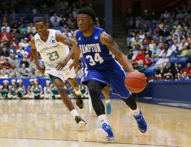 Mar 17, 2015; Dayton, OH, USA; Hampton Pirates guard Reginald Johnson (34) brings the ball up court ahead of Manhattan Jaspers guard Rich Williams (23) during the second half in the first round of ...