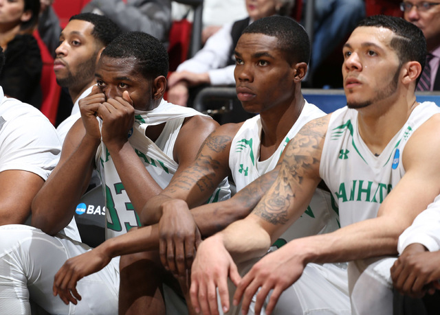 Mar 17, 2015; Dayton, OH, USA; Manhattan Jaspers guard Donovan Kates (33, left) reacts on the bench with teammates after the game against the Hampton Pirates in the first round of the 2015 NCAA To ...