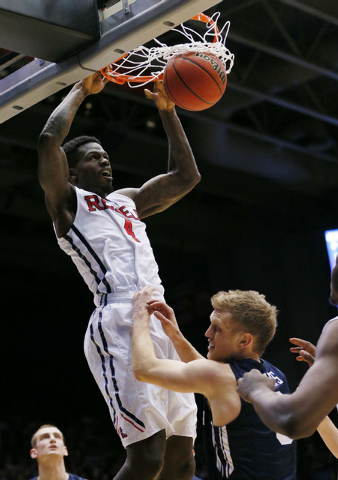 Mar 17, 2015; Dayton, OH, USA; Mississippi Rebels forward M.J. Rhett (4) dunks the ball while defended by Brigham Young Cougars guard Tyler Haws (3) during the second half in the first round of th ...