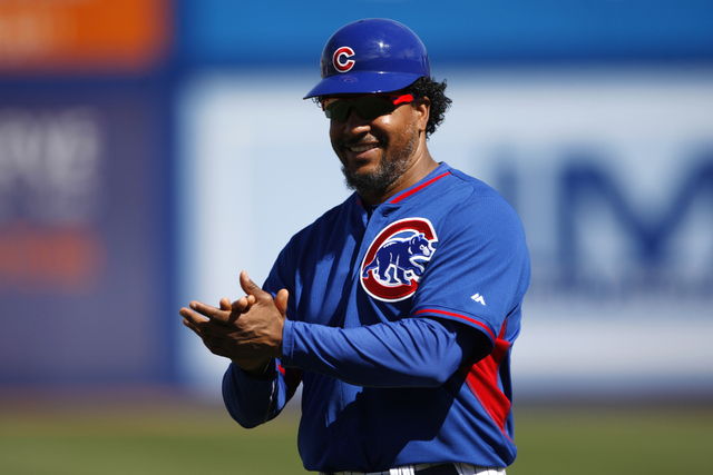 Chicago Cubs first base coach Manny Ramirez, a former Major League Baseball  star, cheers a player in their baseball game against the Oakland Athletics  at Cashman Field in Las Vegas Sunday, March