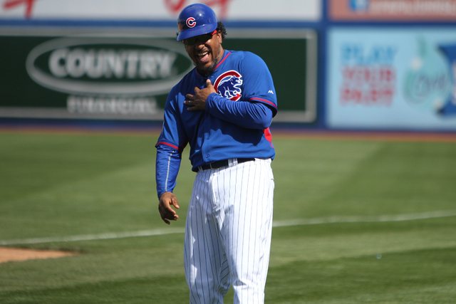 Chicago Cubs first base coach Manny Ramirez, a former Major League Baseball  star, shares a moment with players in their baseball game against the  Oakland Athletics at Cashman Field in Las Vegas