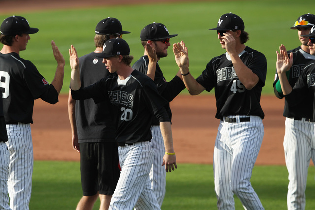 Pitcher Blaze Bohall  (20) high fives with teammates after their 7-1 defeat of Grand Canyon University Tuesday, March 17, 2015 at Earl E. Wilson Stadium. Bohall threw 7 1/3 innings, giving up one  ...