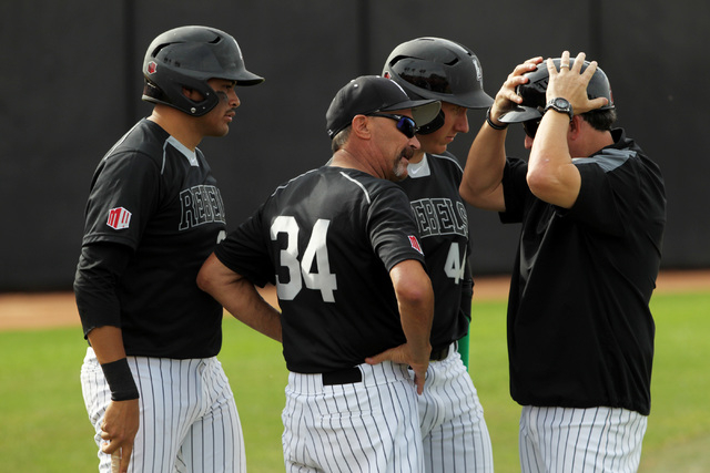UNLV head coach Tim Chambers, center, talks with players and a coach during a pitching change during their 7-1 defeat of Grand Canyon University Tuesday, March 17, 2015 at Earl E. Wilson Stadium.  ...