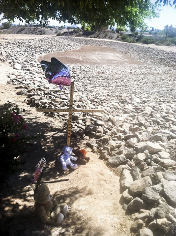 Balloons and stuffed toys are near the lot at Chaparral and Country Club drives in Bullhead City, Arizona, where the body believed to be 8-year-old Isabella Grogan-Cannella was found on Sept. 3, 2 ...