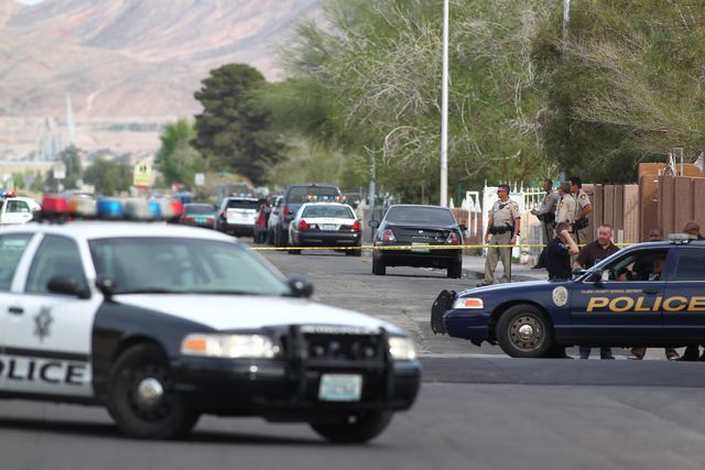 Las Vegas police respond to a barricade situation after reports of a suspect firing at an occupied vehicle, at the intersection of Sandy Lane and Alto Avenue in Las Vegas on Tuesday, March 17, 201 ...