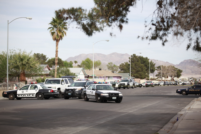 Las Vegas police respond to a barricade situation after reports of a suspect firing at an occupied vehicle, at the intersection of Sandy Lane and Alto Avenue in Las Vegas on Tuesday, March 17, 201 ...