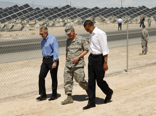 U.S. Senate Majority Leader Harry Reid, D-Nev., left, walks with, continuing from left, U.S. Air Force Col. Howard Belote and President Barack Obama, during a tour of the Nellis Air Force Base Sol ...