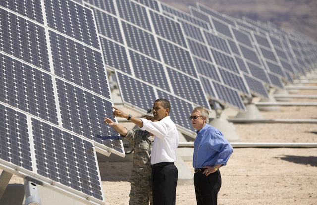 U.S. Air Force Col. Howard Belote, left, leads, continuing from left, President Barack Obama and U.S. Senate Majority Leader Harry Reid, D-Nev., on a tour of the Nellis Air Force Base Solar Power ...