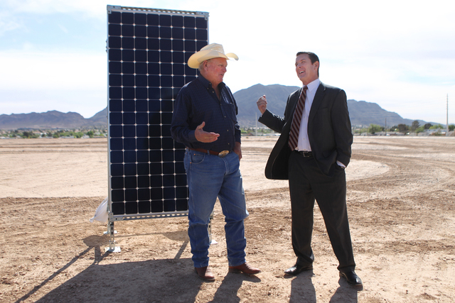 Clark County Commissioner Tom Collins, left, seaks with Patrick Egan, senior vice president for NV Energy, during a ground breaking ceremony for the Nellis Solar Array II project at Nellis Air For ...