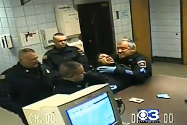 Major puts his hands near Maldonado’s neck, in what former acting chief Thomas Charette says is an effort to keep the blood from her lip from getting on the officers. (Screengrab, CBS 3 Springfield)
