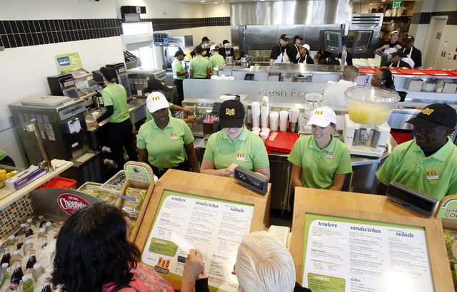 PDQ employees, from left, Chelsea Brown, Debra Phillips, Jaymi Imrisek and Remy Reynold wait on customers Audrey Alexander, lower left, and Barbara Trella during a dress rehearsal for the fast-cas ...