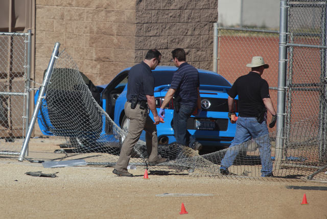 Las Vegas police investigate a suspected street-racing crash Feb. 9 involving two vehicles, one of which rolled over on a baseball field outside of Sunrise Mountain High School, 2575 Los Feliz St. ...