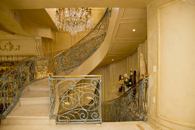Tonya Harvey/Real Estate Millions 
The penthouse's three floors are connected via an ornate, winding iron staircase, which, features 18-carat gold-detailed patina.
