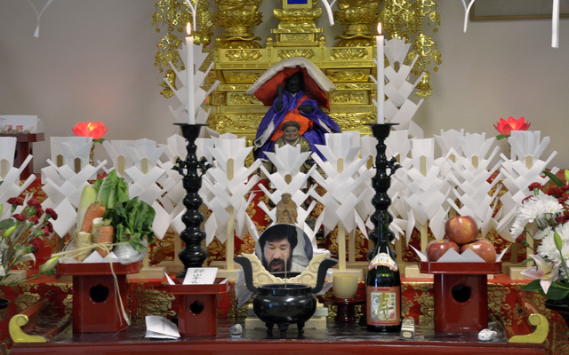 Rev. Douglas Shoda Kanai is seen reflected in a mirror on the altar at the Nichiren Buddhist Kannon Temple of Nevada at 1600 E. Sahara Ave. in Las Vegas on Sunday, March 8, 2015. Rev. Kanai was pa ...